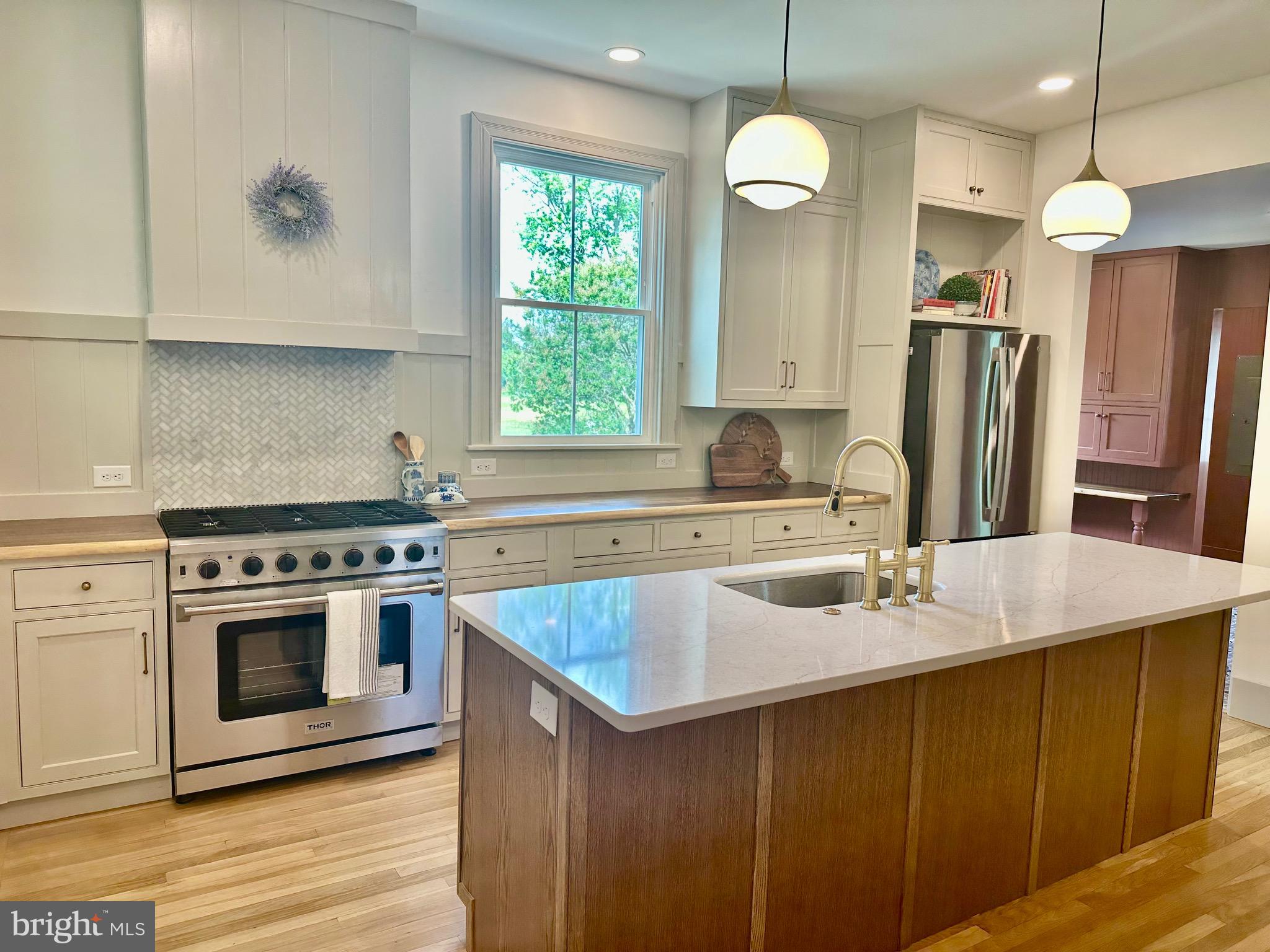 3860 Main Street Trappe, MD 21673 - Photo 15 of 58 a kitchen with stainless steel appliances granite countertop a sink stove and refrigerator