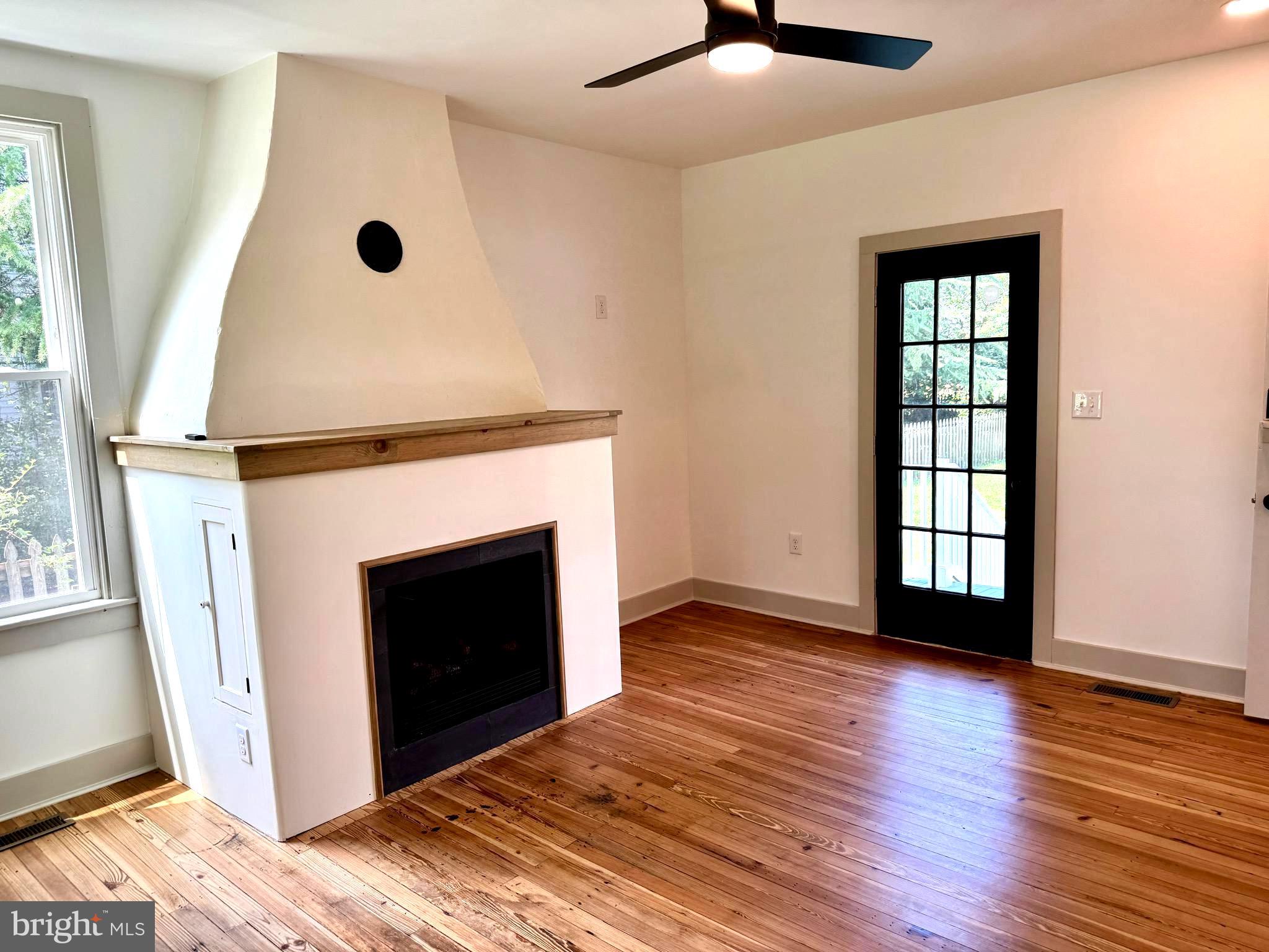 3860 Main Street Trappe, MD 21673 - Photo 32 of 58 a view of an empty room with exposed radiator and fireplace