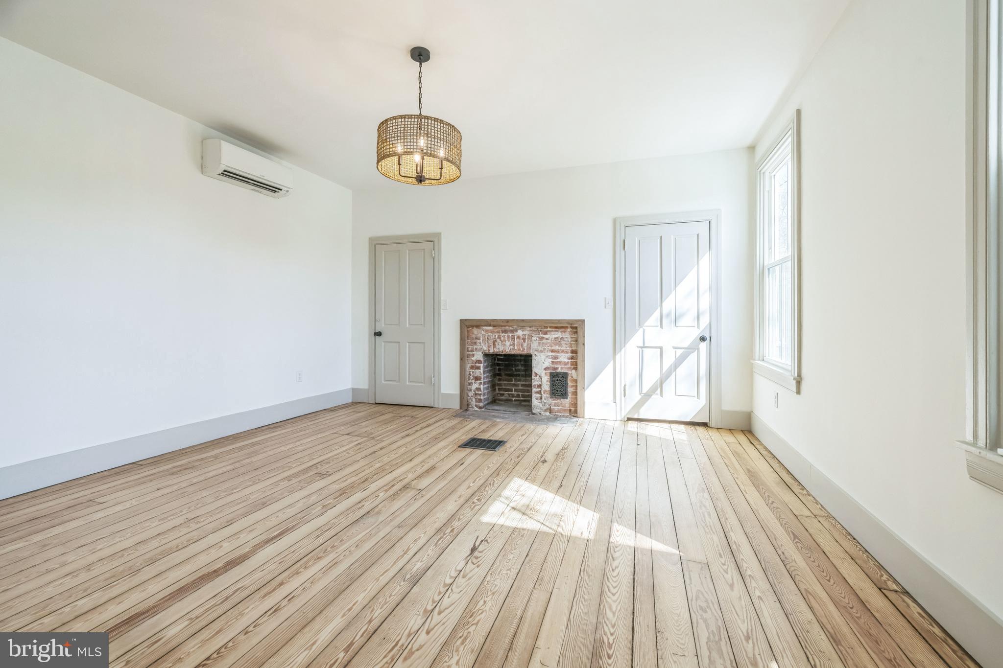 3860 Main Street Trappe, MD 21673 - Photo 35 of 58 a view of a livingroom with wooden floor and a fireplace