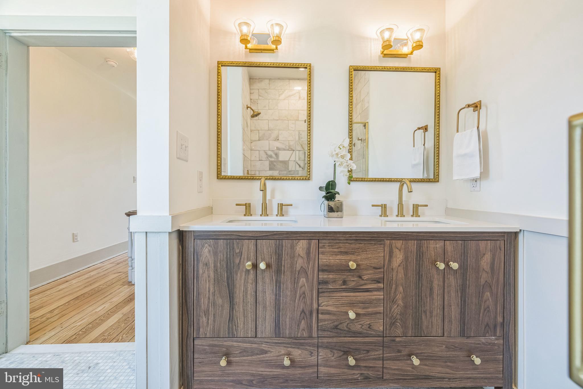 3860 Main Street Trappe, MD 21673 - Photo 38 of 58 a bathroom with double vanity sink and a mirror