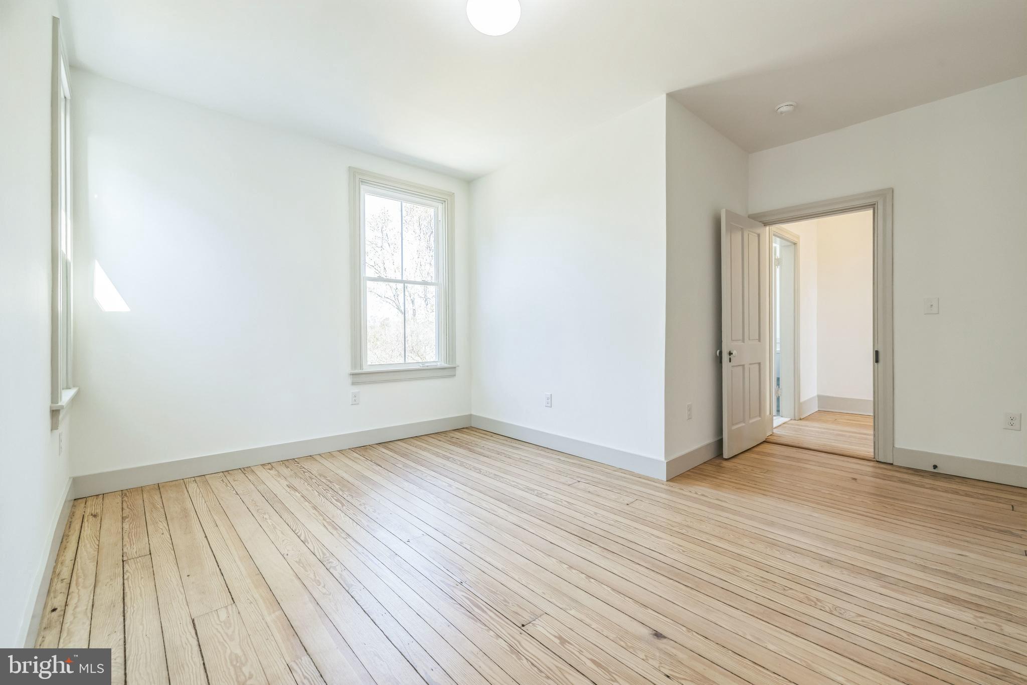 3860 Main Street Trappe, MD 21673 - Photo 40 of 58 an empty room with wooden floor and windows