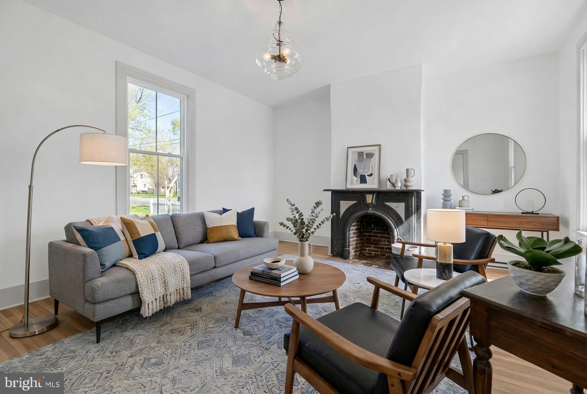 3860 Main Street Trappe, MD 21673 - Photo 7 of 58 a living room with furniture a fireplace and a large mirror