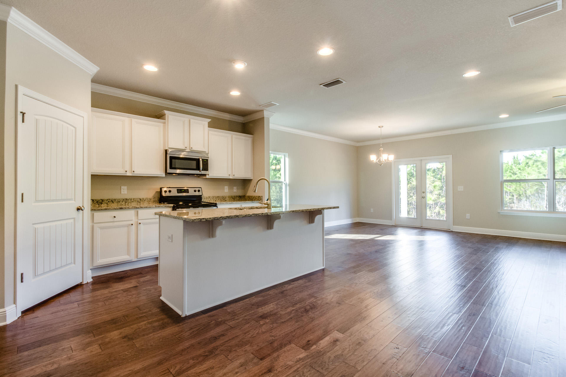 600 Las Roblas Grande Drive Santa Rosa Beach, FL 32459 - Photo 2 of 12 a kitchen with wooden floors and white appliances