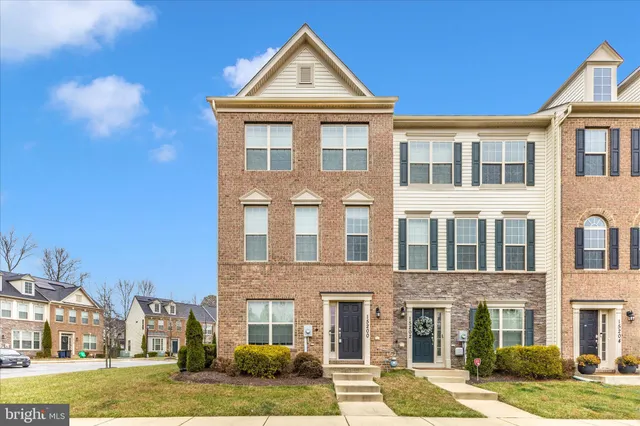a front view of a residential apartment building with a yard