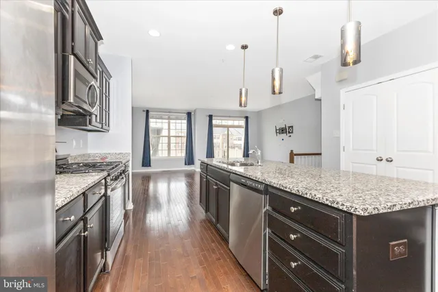 a kitchen with stainless steel appliances granite countertop a stove and a sink