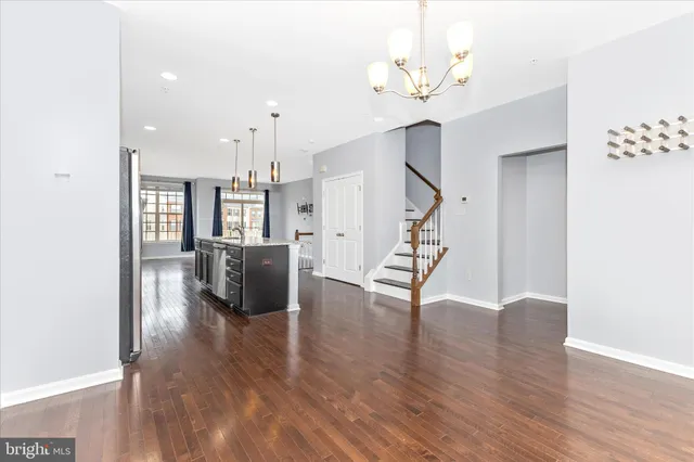 a view of a livingroom with wooden floor and a ceiling fan
