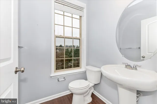 a bathroom with a toilet sink and a mirror