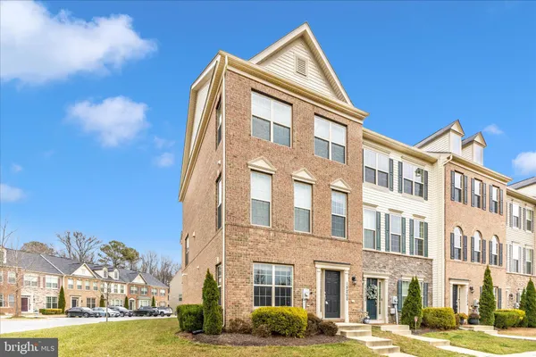 a front view of a building with a yard