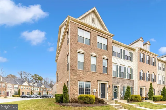 a front view of a building with a yard
