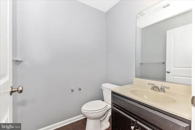 a bathroom with a sink toilet and a mirror