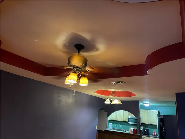 a kitchen with stainless steel appliances a sink cabinets and a wooden floor