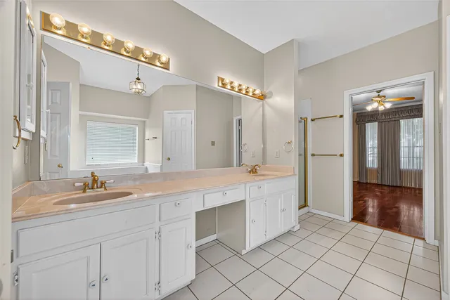 a spacious bathroom with a double vanity sink mirror and double