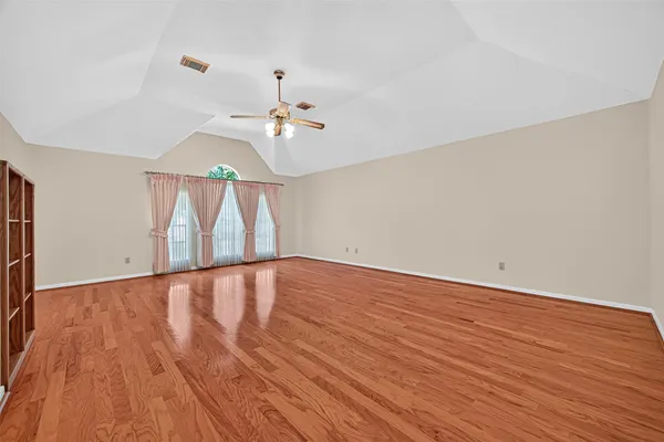 a view of an empty room and wooden floor