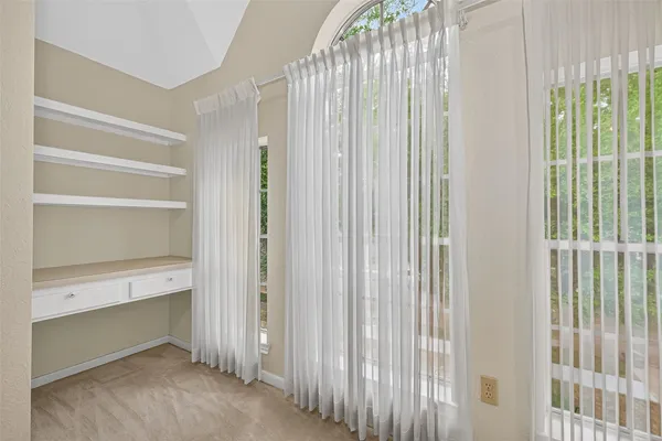 a view of an empty room with furniture