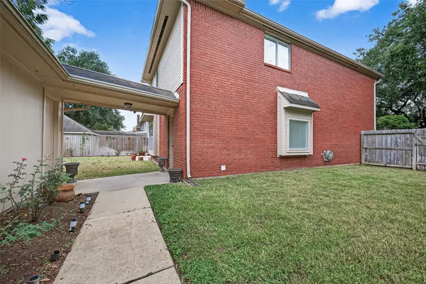 a front view of house with a garden