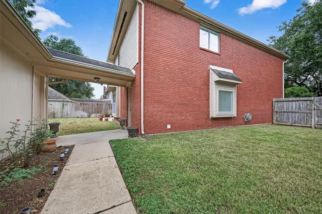 a front view of house with a garden