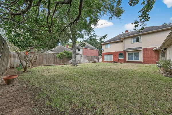 a view of a backyard with wooden fence