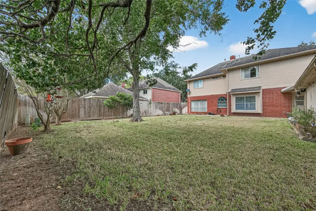 a view of a backyard with wooden fence