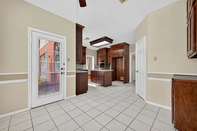 a view of a kitchen with furniture and an empty room