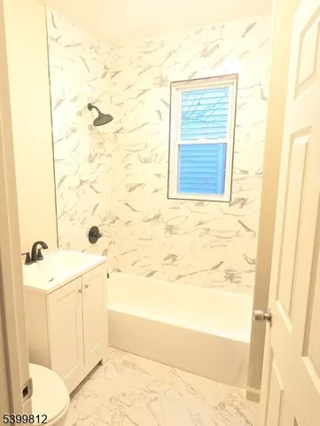 a bathroom with a bathtub and shower