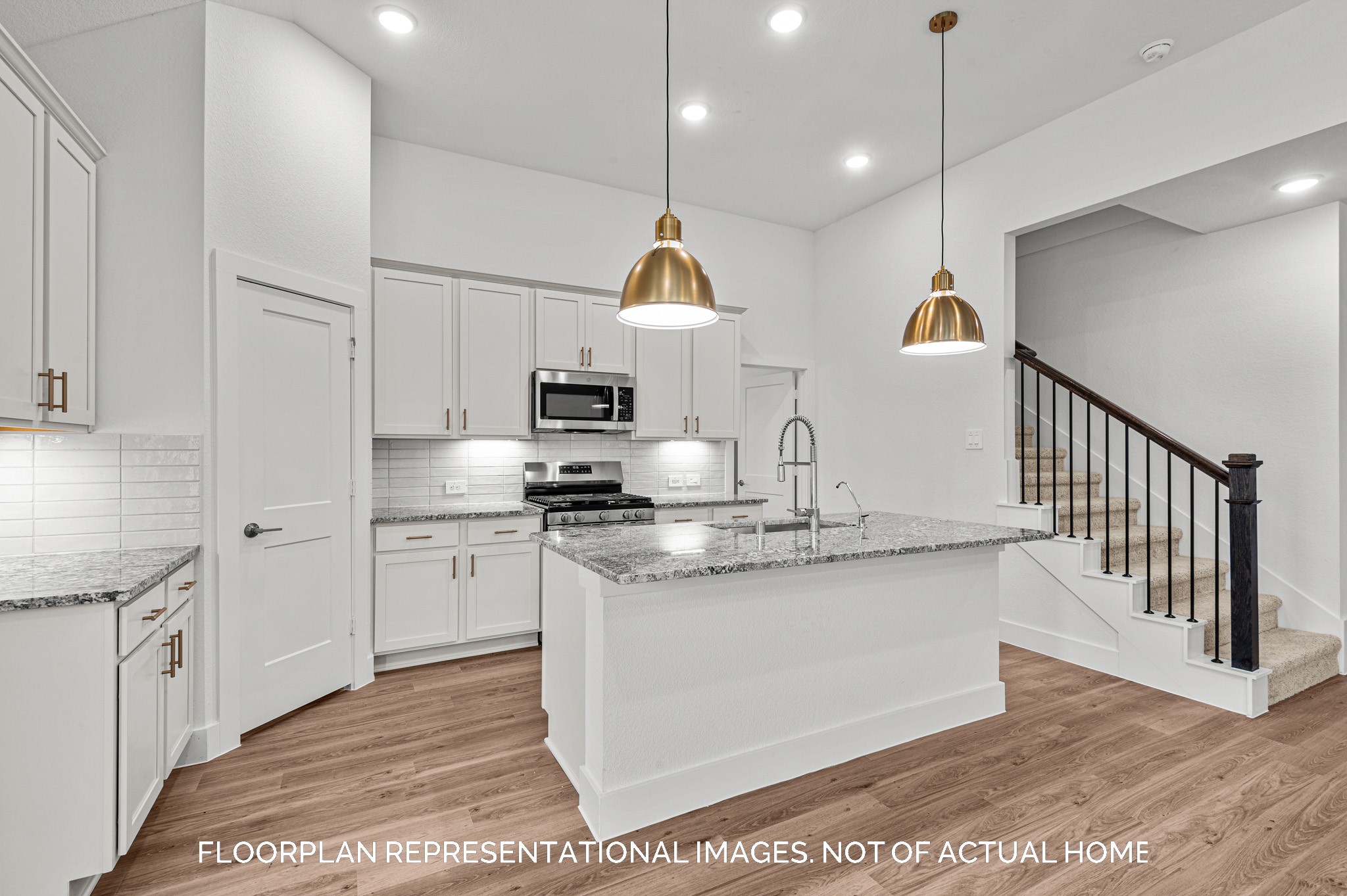5707 Sunland Trail Fulshear, TX 77441 - Photo 5 of 21 a kitchen with stainless steel appliances granite countertop a sink a stove a refrigerator and island with wooden floor