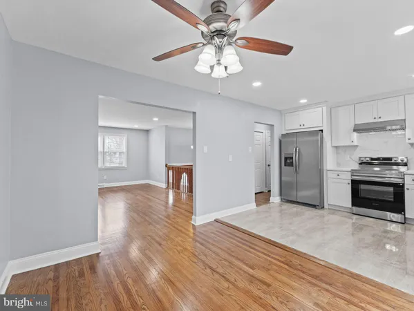 a view of a kitchen with a sink and a refrigerator