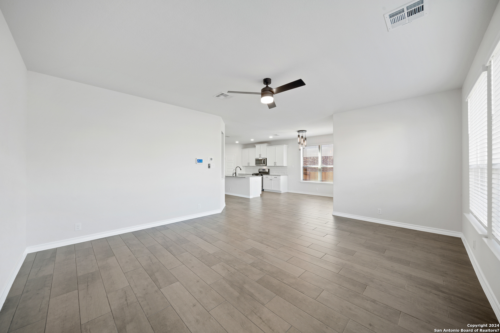 648 Amber Creek Cibolo, TX 78108 - Photo 11 of 34 wooden floor in an empty room with a window