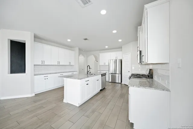 a large kitchen with a lot of counter space and a sink