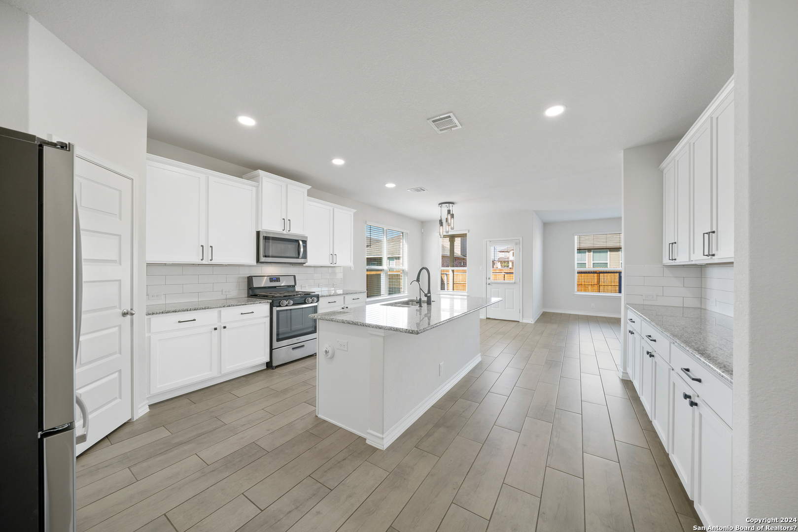 648 Amber Creek Cibolo, TX 78108 - Photo 15 of 34 a kitchen with white cabinets and stainless steel appliances