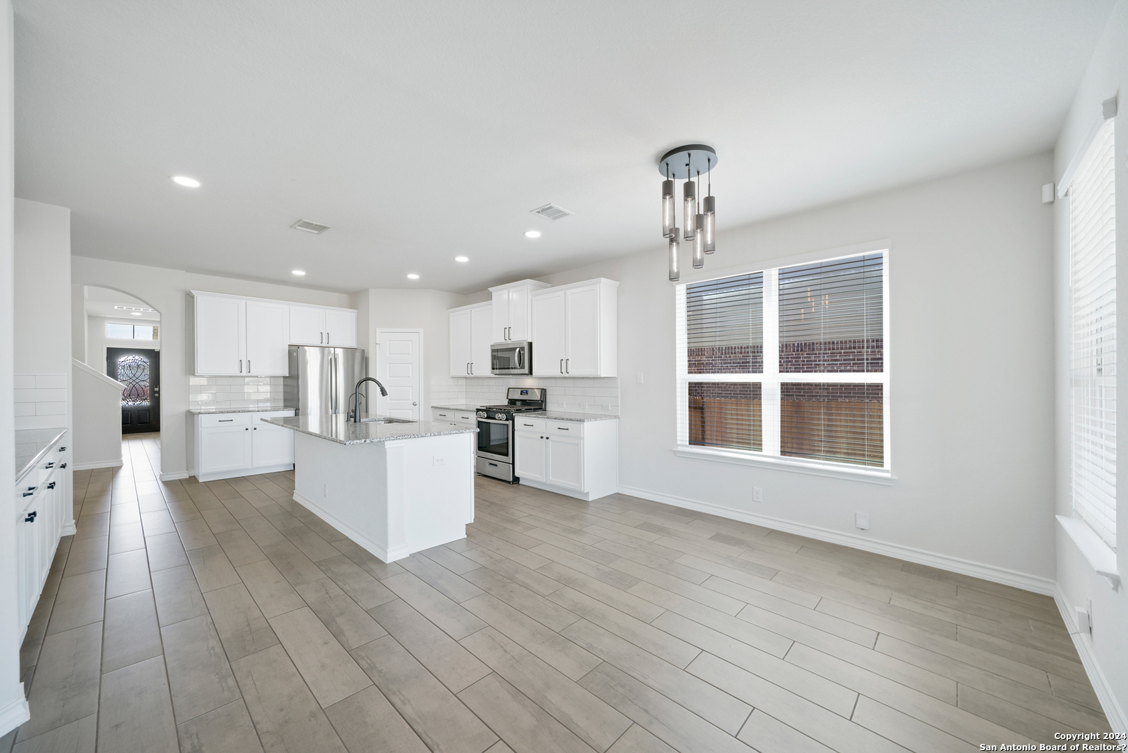 648 Amber Creek Cibolo, TX 78108 - Photo 17 of 34 a view of a big room with wooden floor and windows