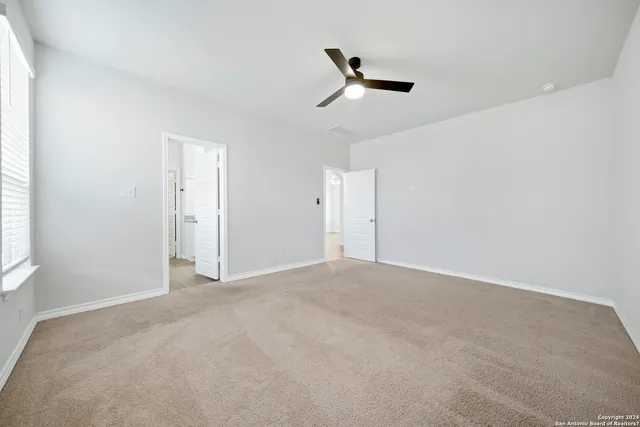 an empty room with a empty space and windows