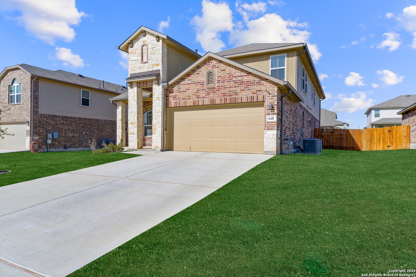 648 Amber Creek Cibolo, TX 78108 - Photo 2 of 34 a front view of a house with a yard and garage