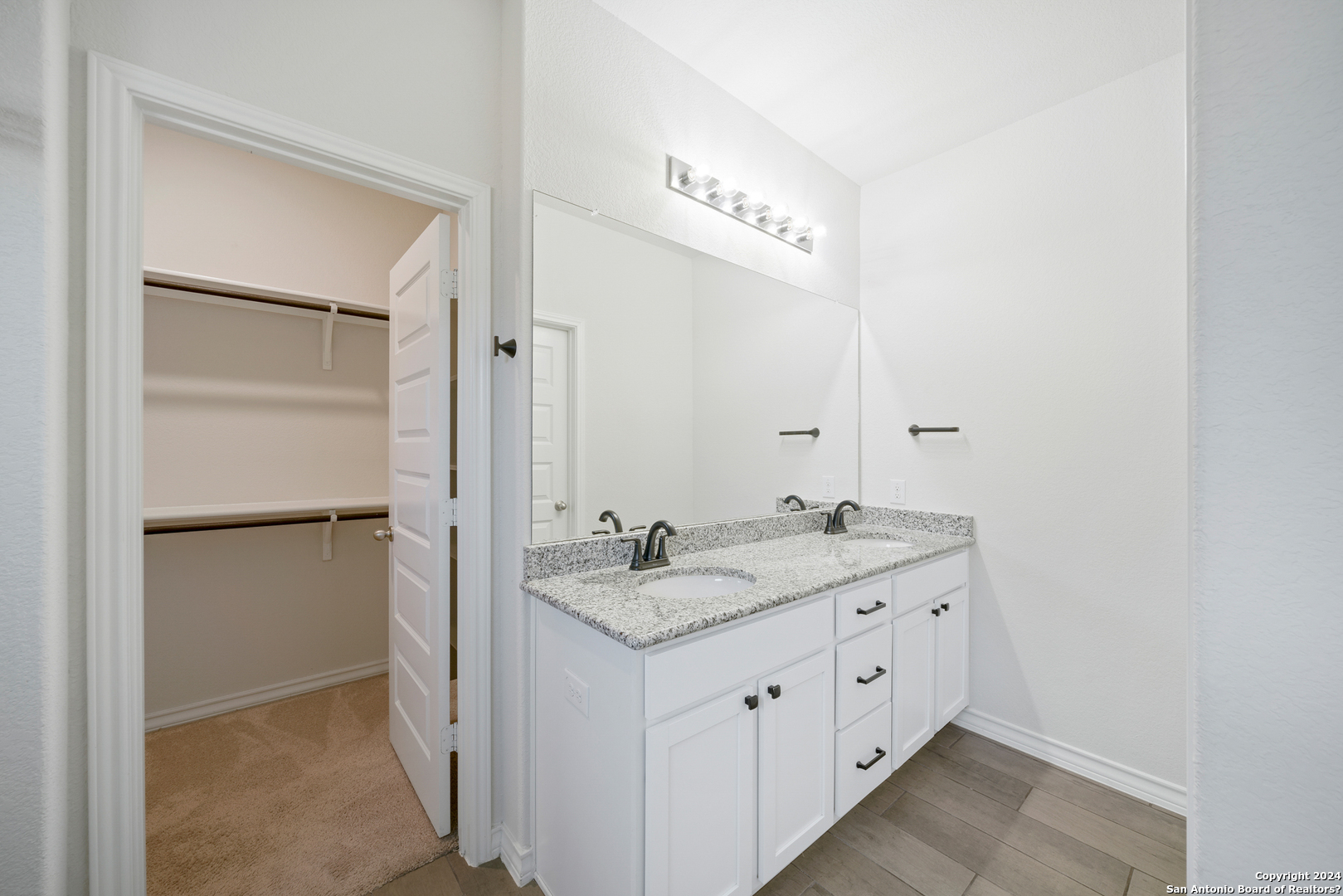648 Amber Creek Cibolo, TX 78108 - Photo 21 of 34 a spacious bathroom with a granite countertop sink and a mirror