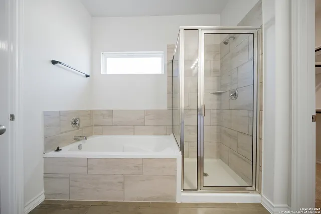 a bathroom with a bathtub and shower