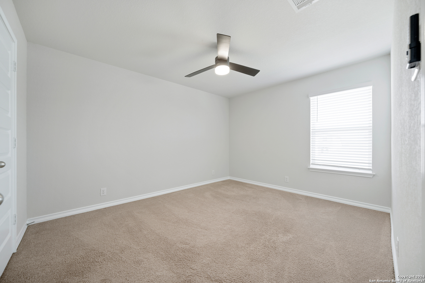648 Amber Creek Cibolo, TX 78108 - Photo 27 of 34 an empty room with a window and ceiling fan