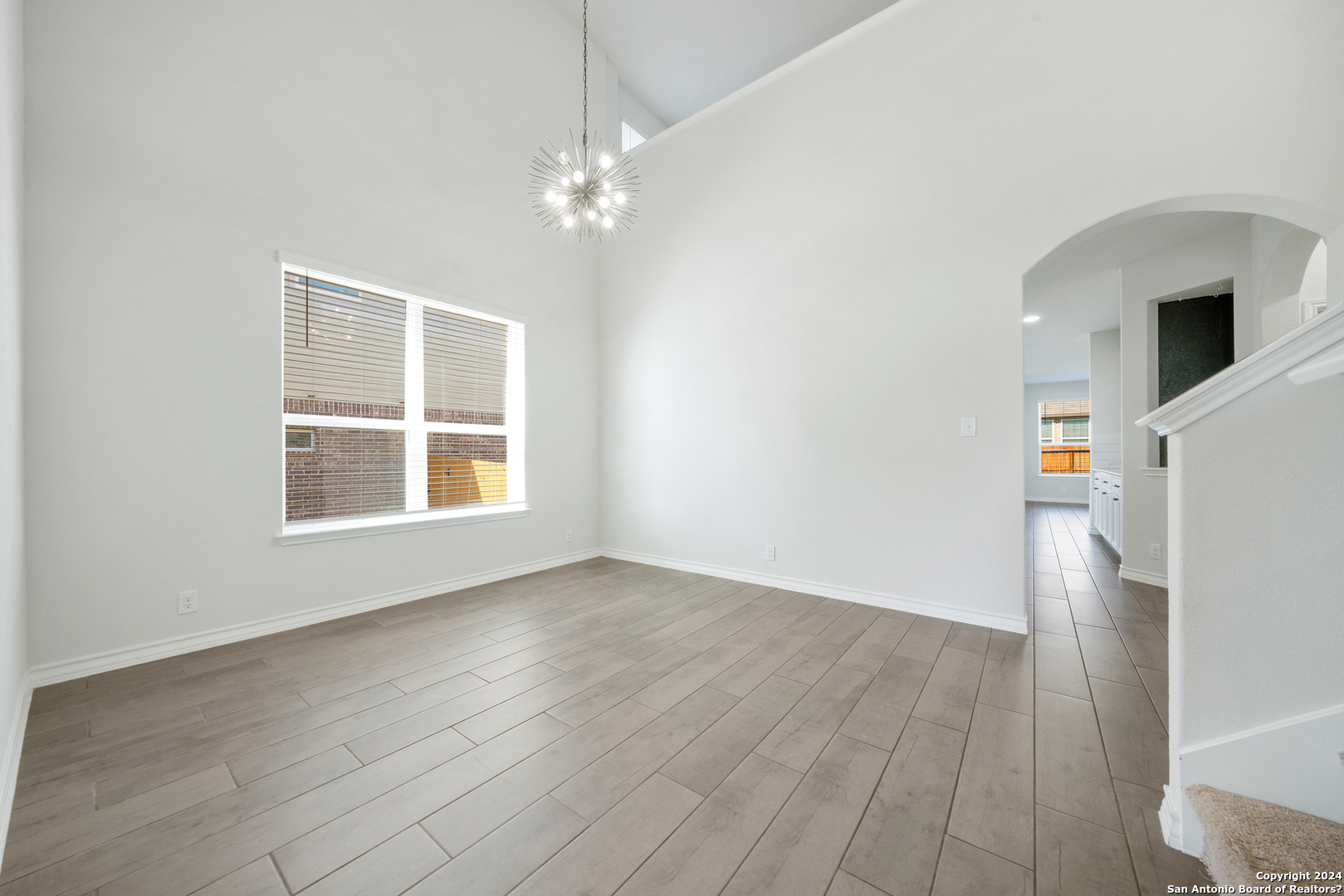 648 Amber Creek Cibolo, TX 78108 - Photo 8 of 34 an empty room with wooden floor cabinet and windows