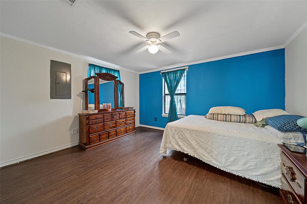 1917 Bell Street Waco, TX 76711 - Photo 11 of 17 a bedroom with a bed and a chandelier
