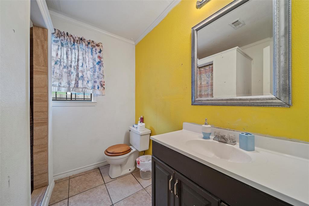 1917 Bell Street Waco, TX 76711 - Photo 10 of 17 a bathroom with a granite countertop sink and a mirror