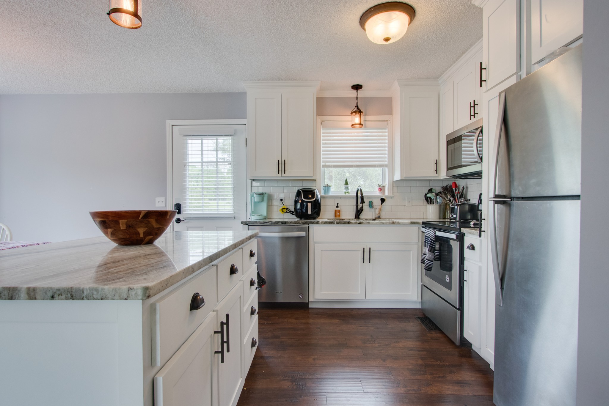 576 Bellwood Road Lebanon, TN 37087 - Photo 3 of 34 a kitchen with a sink a refrigerator a stove and white cabinets