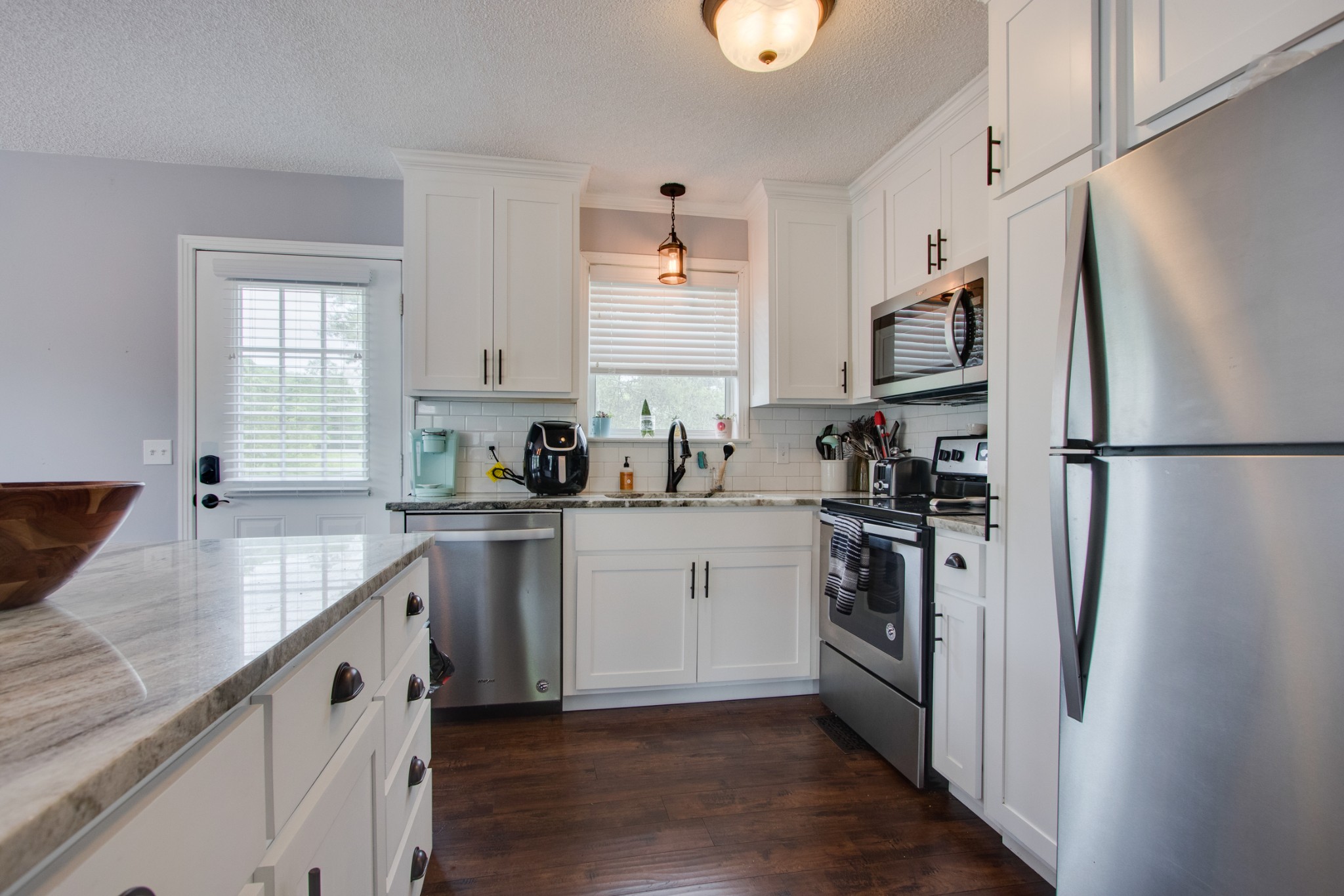 576 Bellwood Road Lebanon, TN 37087 - Photo 9 of 34 a kitchen with white cabinets and stainless steel appliances