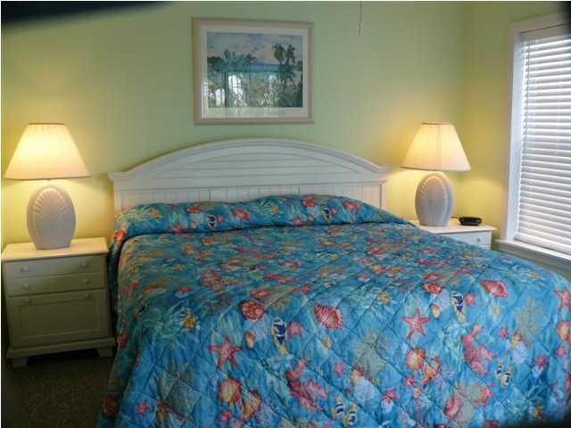 3799 Hwy Santa Rosa Beach, Unit 10B 30A Santa Rosa Beach, FL 32459 - Photo 13 of 16 a bedroom with a bed and a lamp on dresser