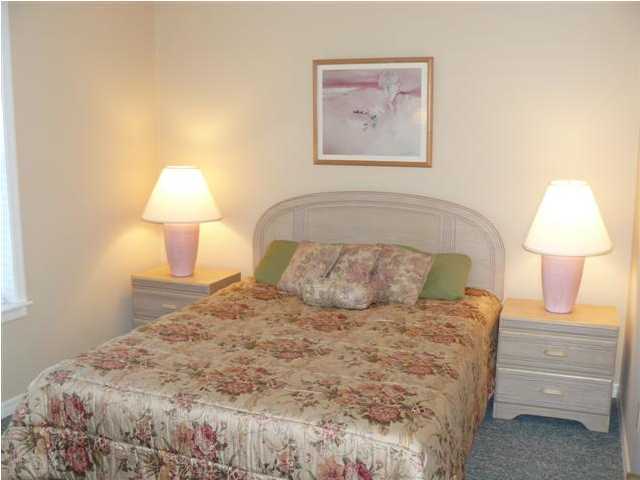 3799 Hwy Santa Rosa Beach, Unit 10B 30A Santa Rosa Beach, FL 32459 - Photo 14 of 16 a bedroom with a bed and a lamp