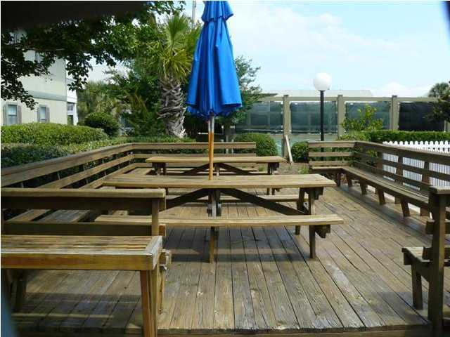 3799 Hwy Santa Rosa Beach, Unit 10B 30A Santa Rosa Beach, FL 32459 - Photo 5 of 16 a view of a wooden chairs and table on the wooden deck