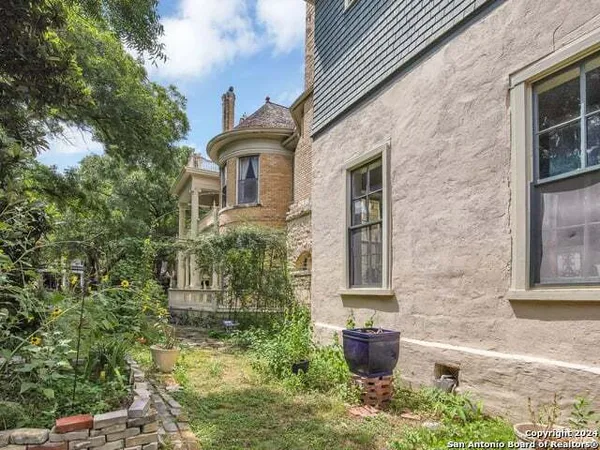 a front view of a house with potted plants