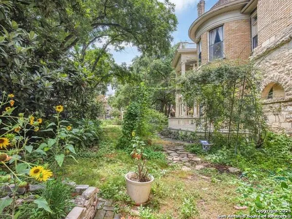 a front view of a multi story residential apartment building with a garden