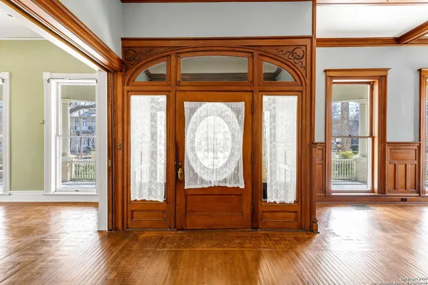 a view of an entryway with a fireplace cabinet and a fireplace