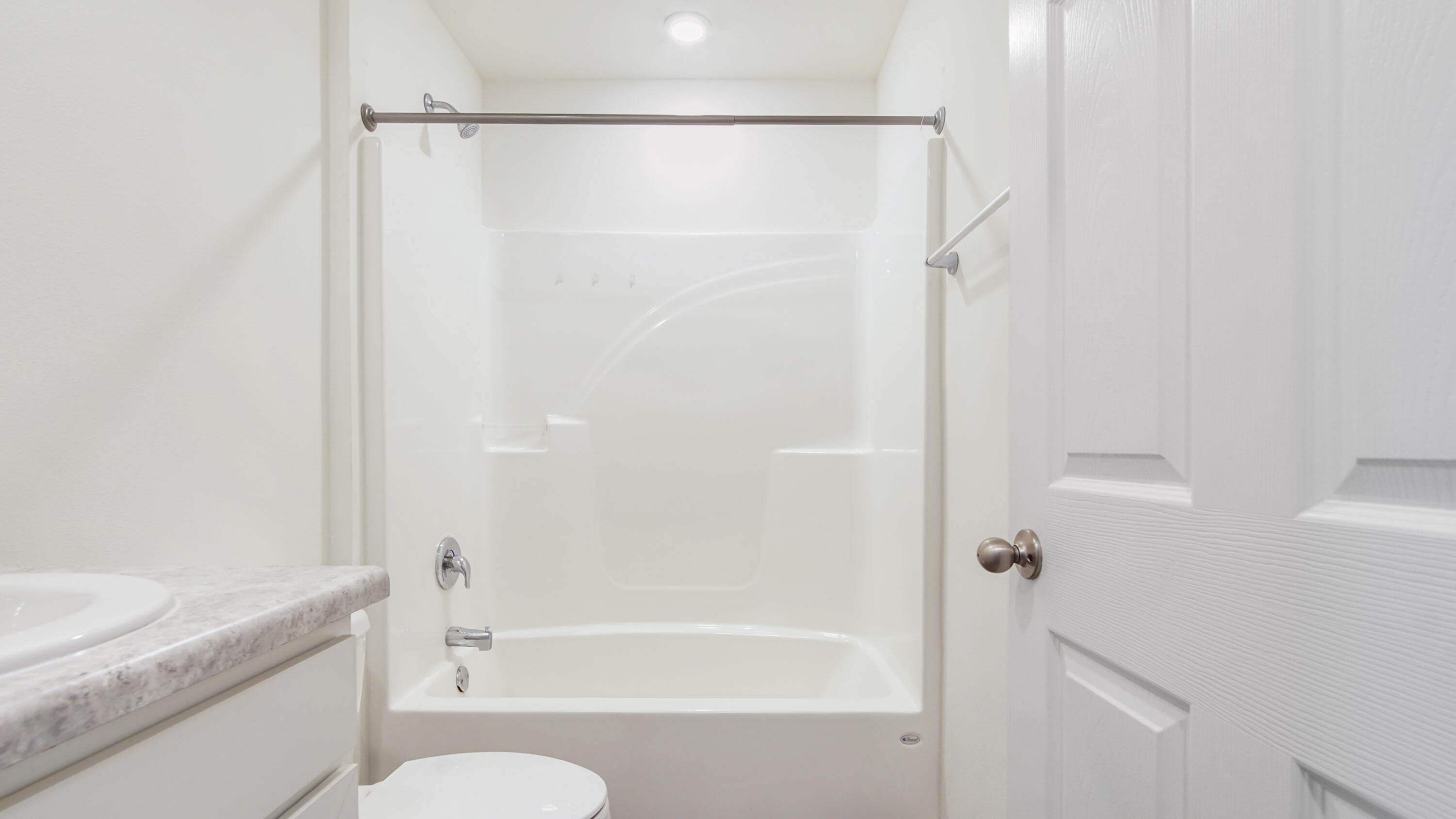 720 Riverwalk Circle Freeport, FL 32439 - Photo 18 of 50 a bathroom with a granite countertop bathtub shower sink vanity and toilet