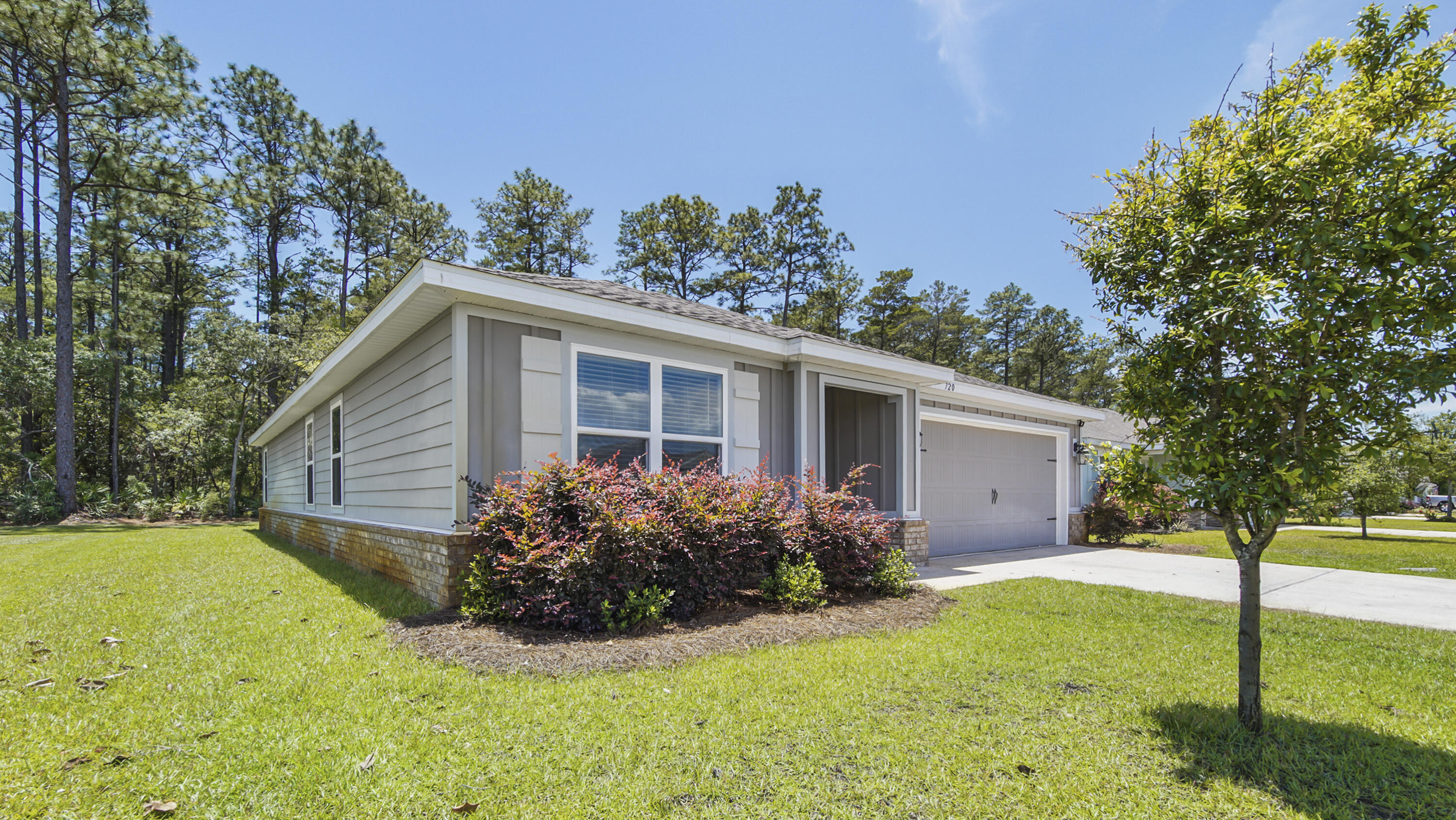 720 Riverwalk Circle Freeport, FL 32439 - Photo 2 of 50 a view of a house with backyard and garden