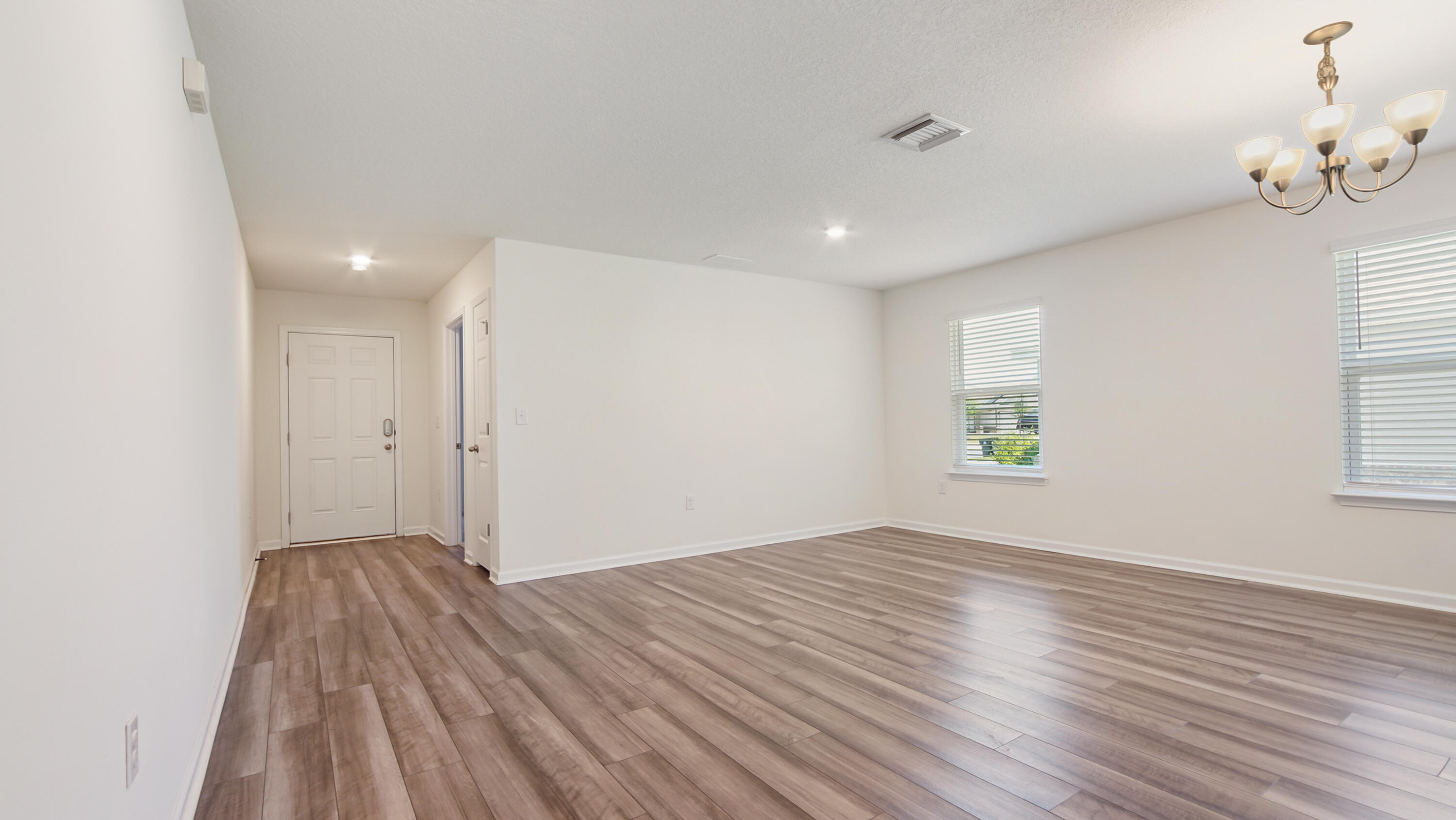720 Riverwalk Circle Freeport, FL 32439 - Photo 24 of 50 wooden floor in an empty room with a window