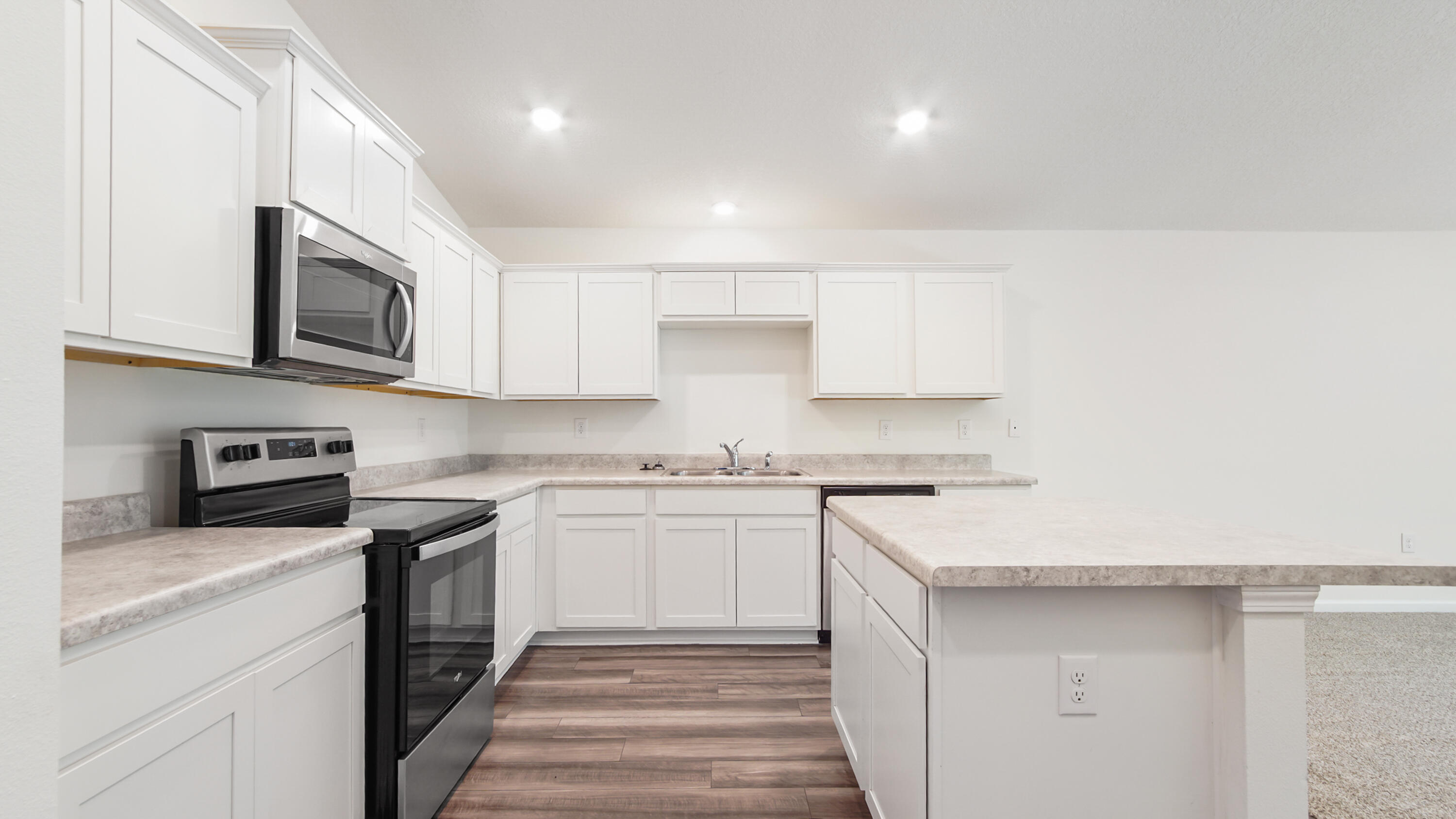 720 Riverwalk Circle Freeport, FL 32439 - Photo 26 of 50 a kitchen with stainless steel appliances granite countertop a sink stove and microwave